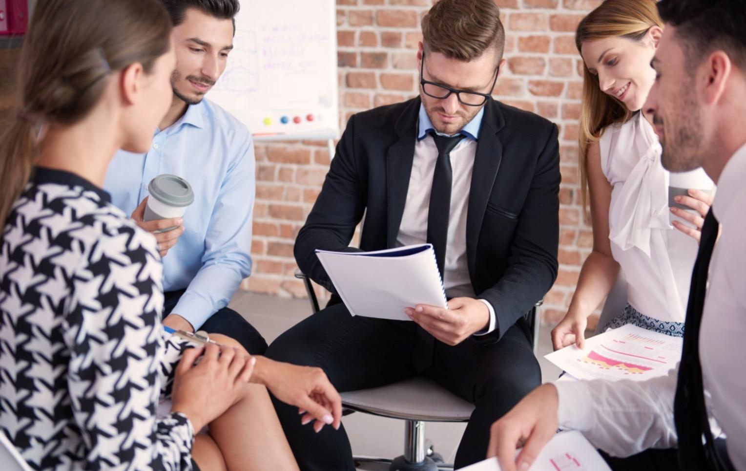 Finance professionals analyzing budget reports during practical training workshop